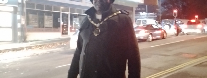 Town Mayor in front of Christmas lights on Chalet Hill